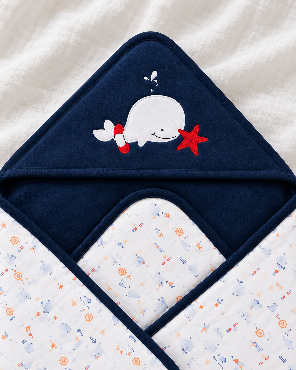 Funny Bunny navy hooded baby wrap, whale hood embroidery
