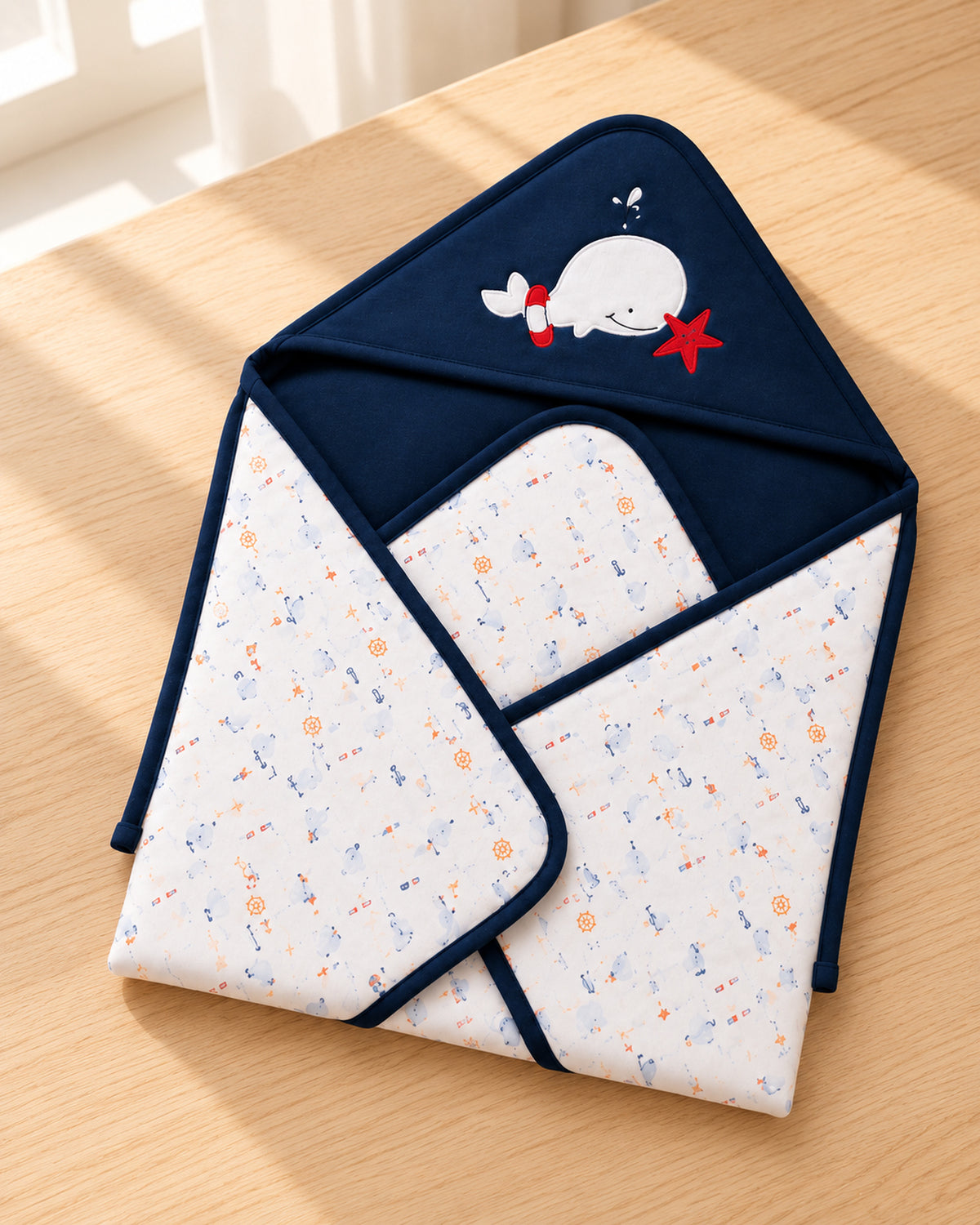 Funny Bunny navy hooded baby wrap, three-quarter tabletop view