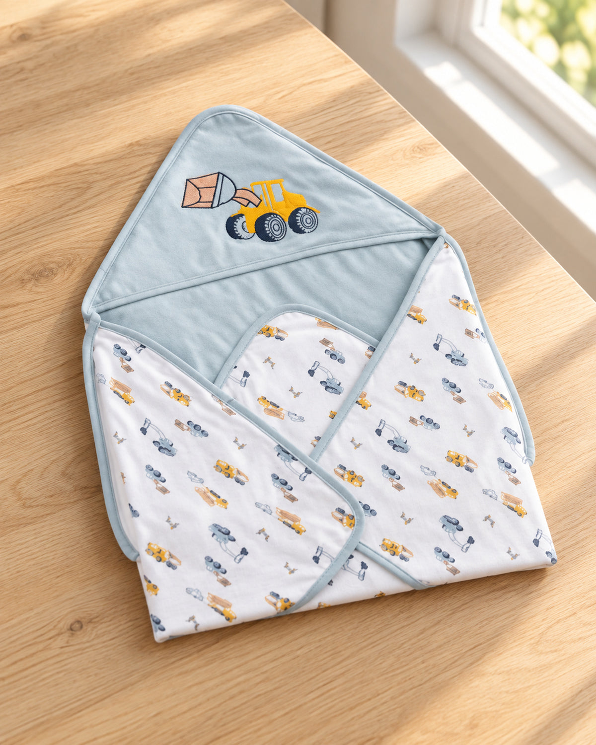 Funny Bunny light blue hooded baby wrap, three-quarter tabletop