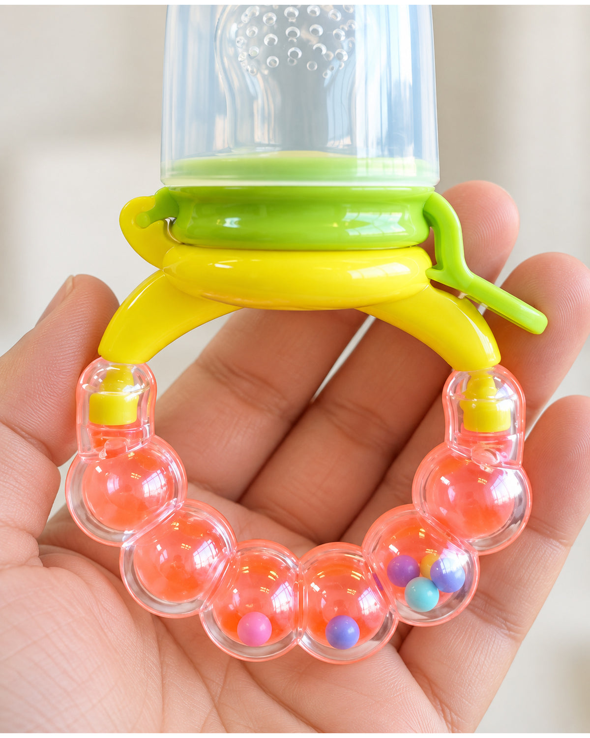 Baby fruit feeder teether, enclosed beads and grip ring detail