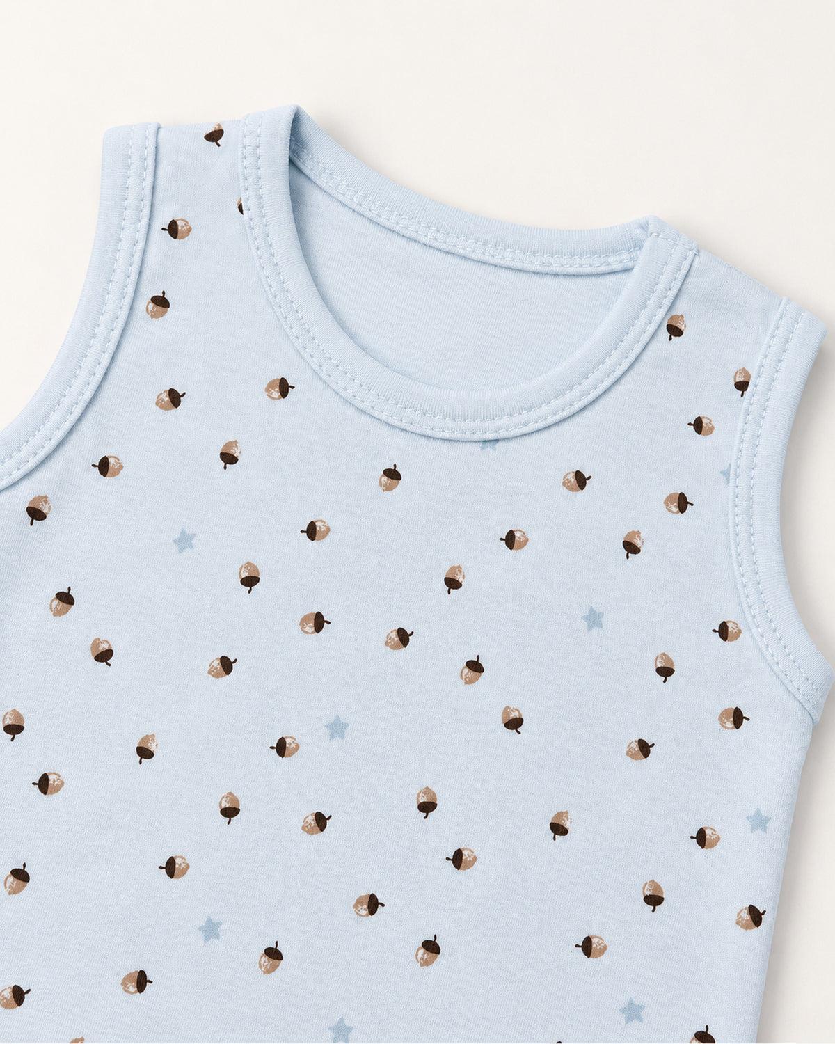Sky blue acorn and star bodysuit neckline and armhole stitching detail