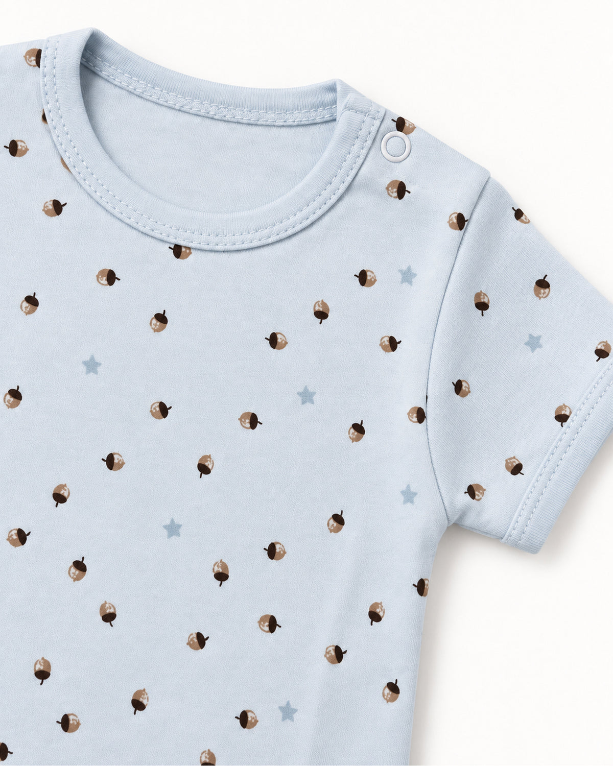 Pale blue acorn and stars bodysuit shoulder snap, neckline and sleeve stitching detail