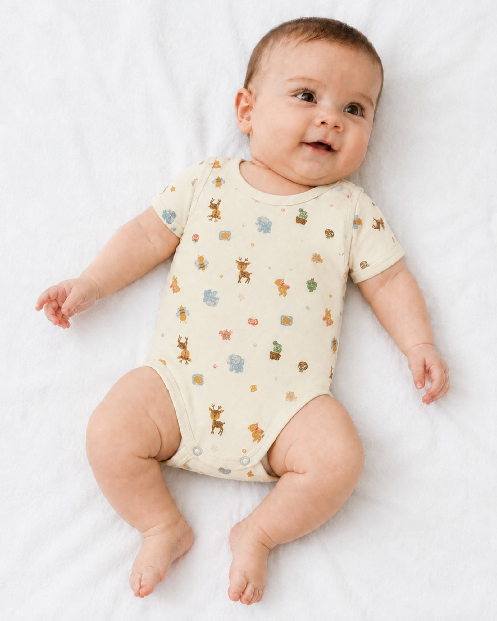 Baby wearing pale yellow short-sleeve crayon woodland animal print bodysuit on white