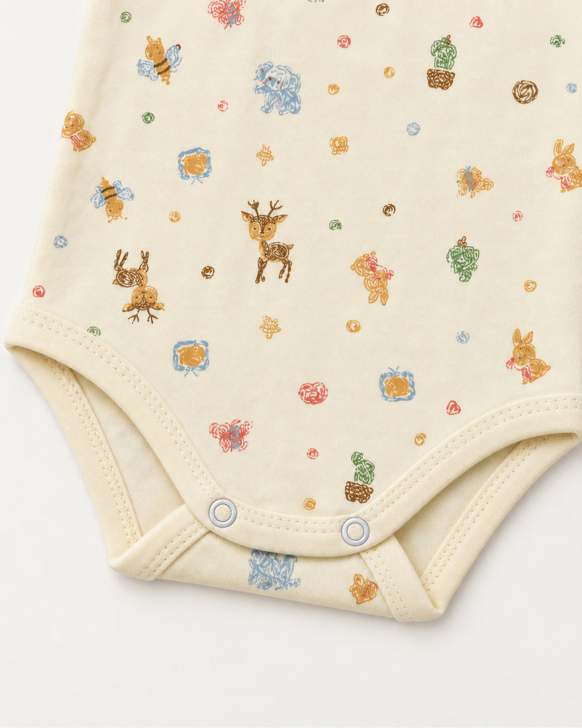 Pale yellow woodland bodysuit leg binding and two bottom press snap detail
