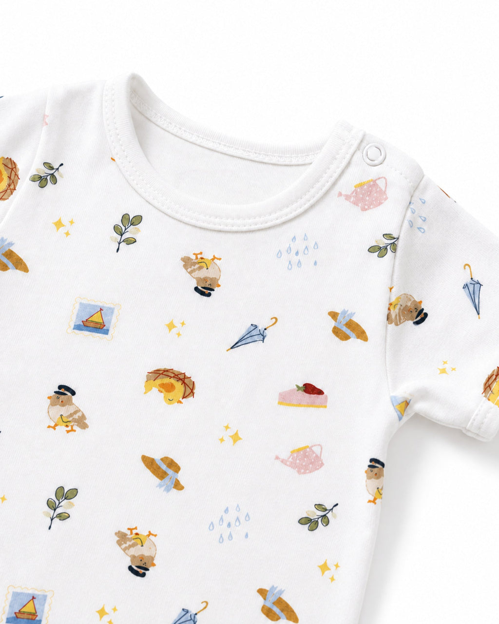White baby bodysuit neckline, shoulder snap and picnic travel print detail on white