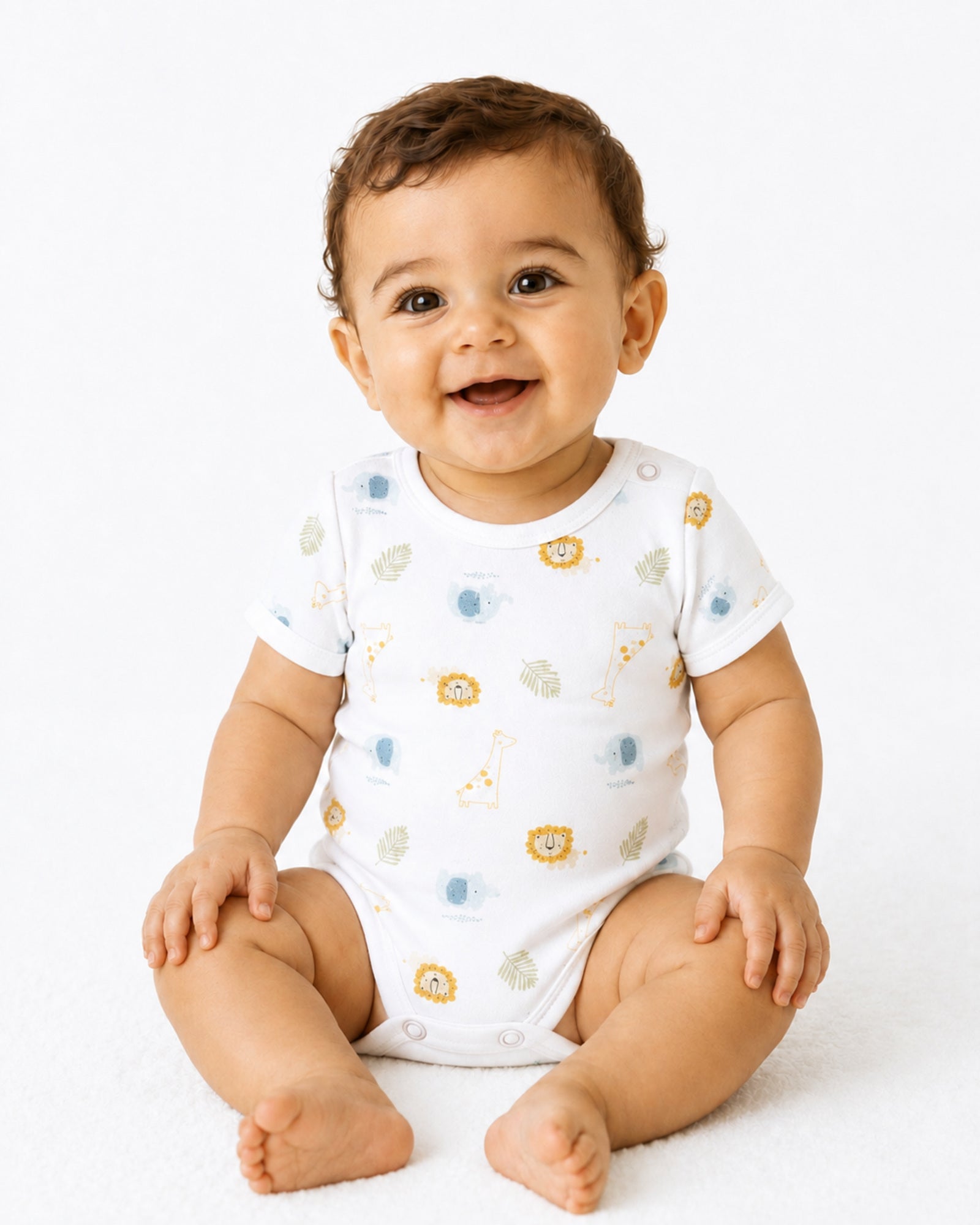 Smiling seated baby wearing white short-sleeve safari animal print bodysuit on white