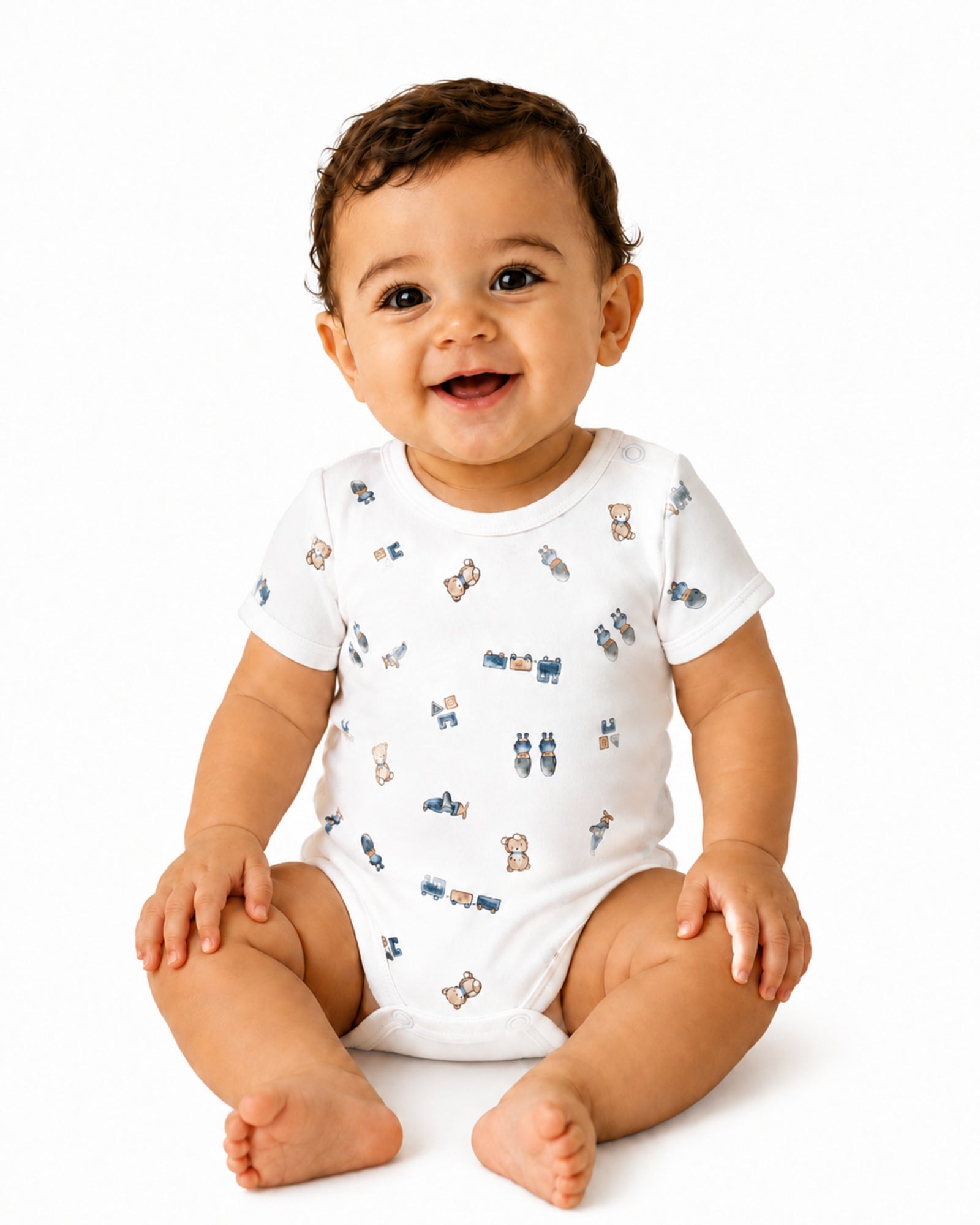 Smiling baby wearing white short-sleeve teddy bear, train and toys print bodysuit on white