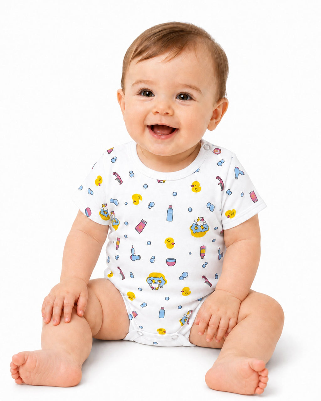Smiling baby wearing white short-sleeve ducks and bath-time print bodysuit on white