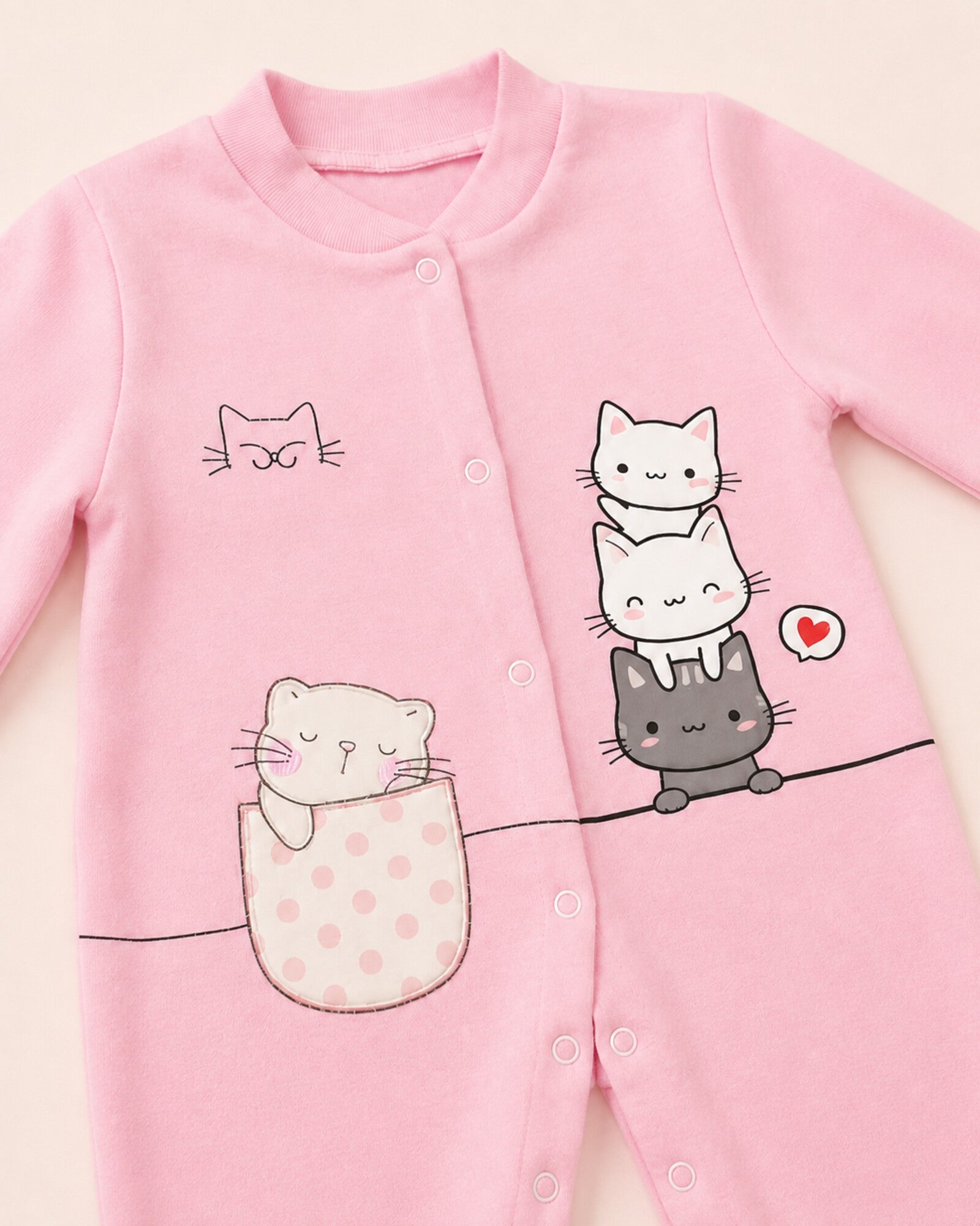 Cat-print sleepsuit neckline, snap placket and pocket detail