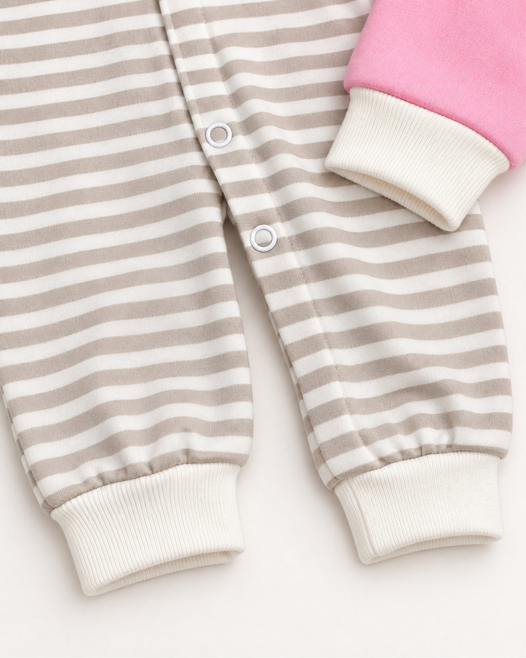 Pink dinosaur sleepsuit striped leg, press snap and ivory cuff detail
