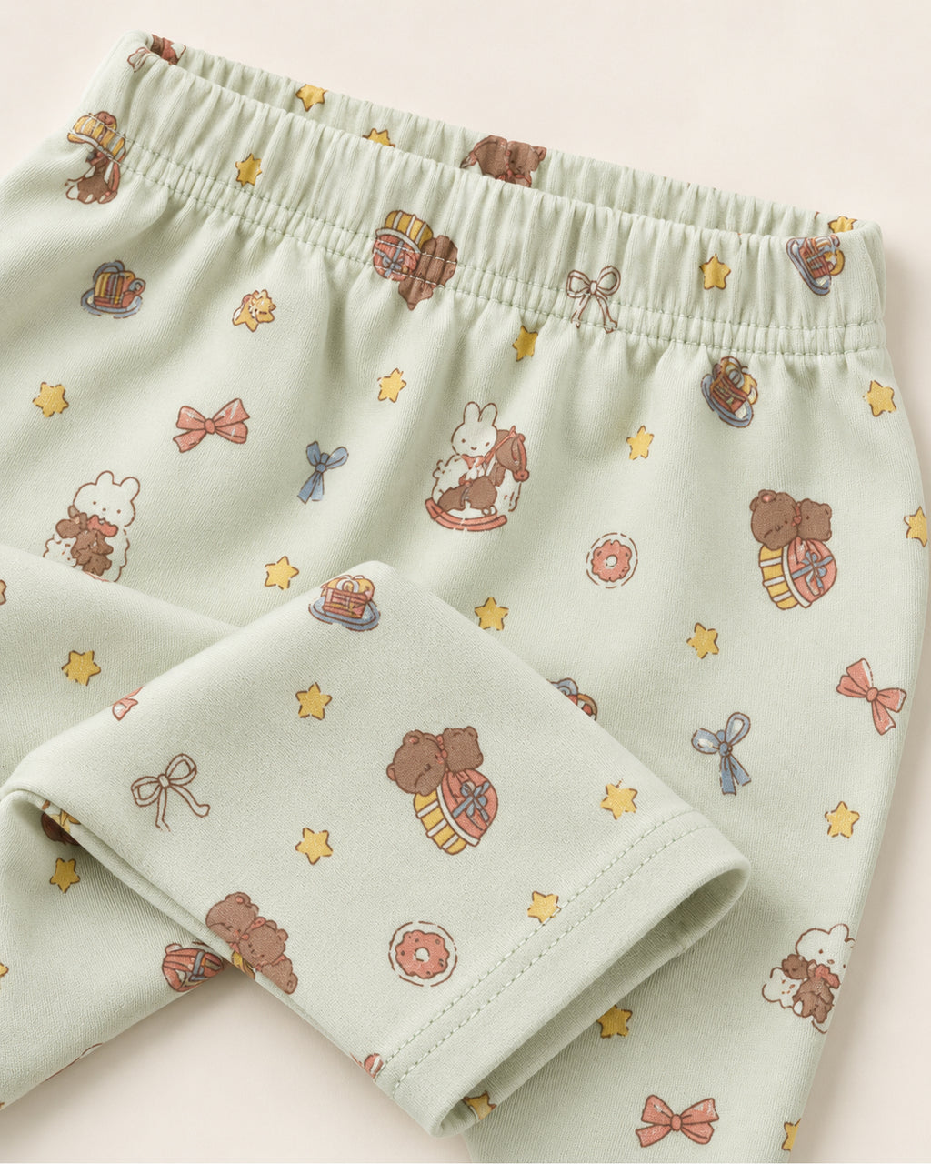 Pale mint teddy bear and rocking horse print trousers elastic waistband and stitched ankle hem detail