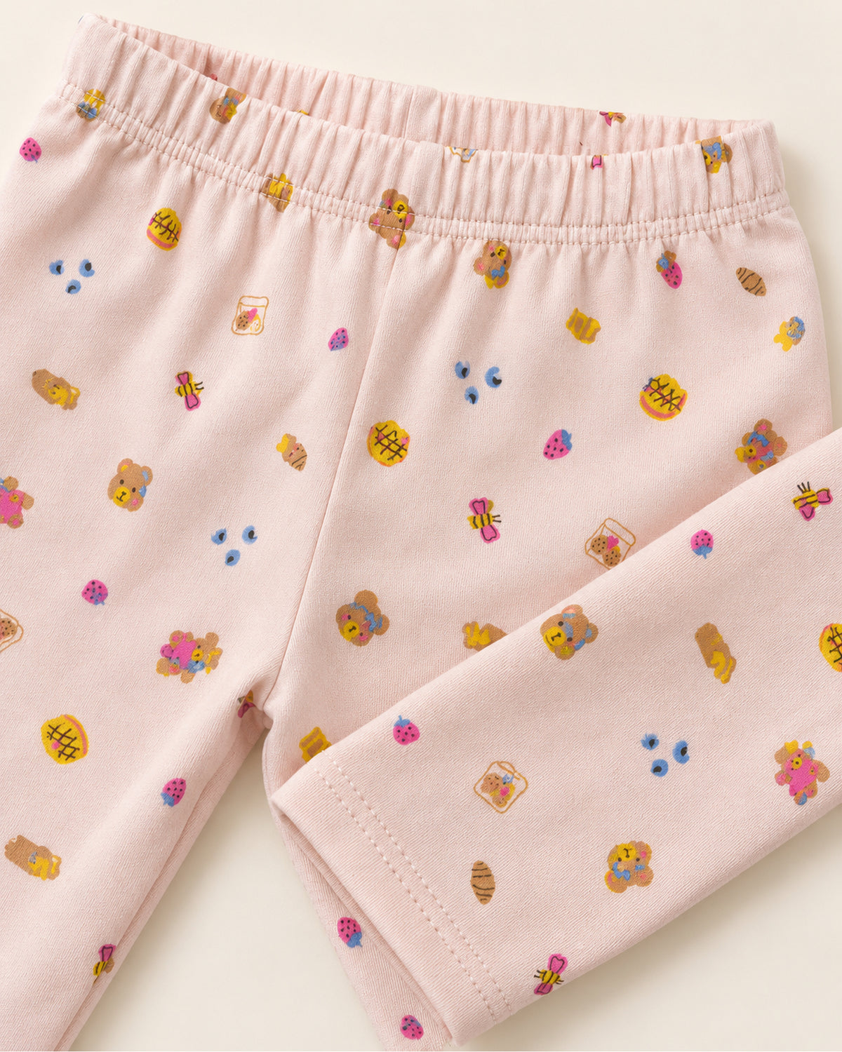 Pale pink teddy bear treats print trousers elastic waistband and stitched ankle hem detail