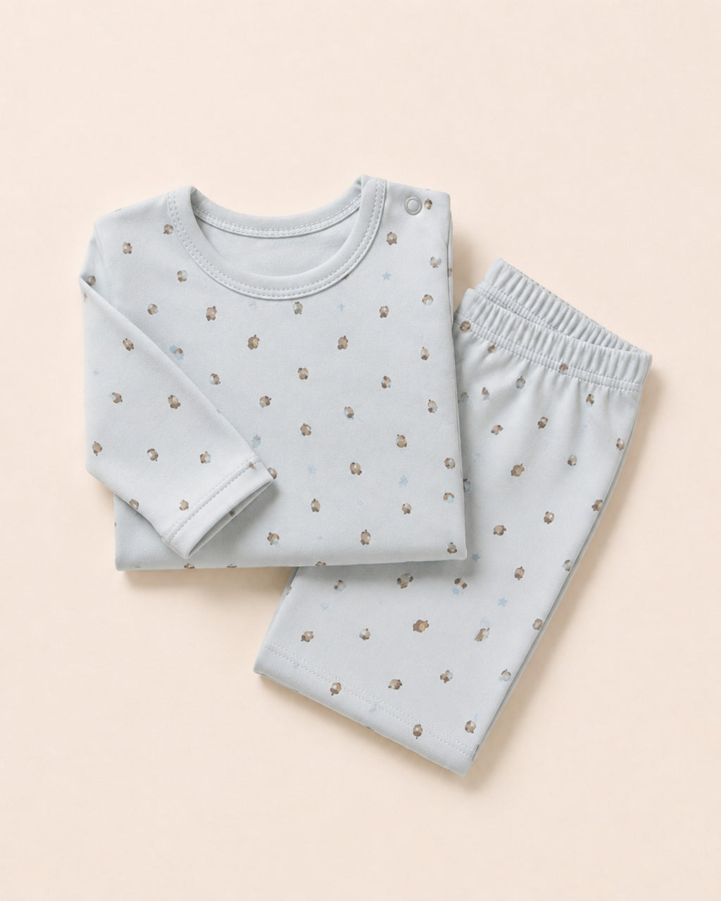 Pale powder-blue long-sleeve baby top and matching trousers, folded composition