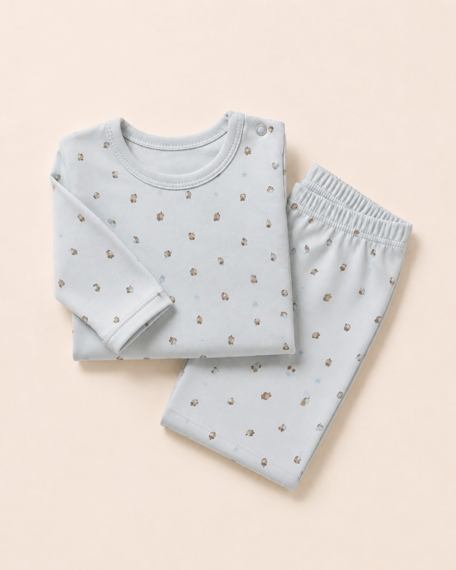 Pale powder-blue long-sleeve baby top and matching trousers, folded composition