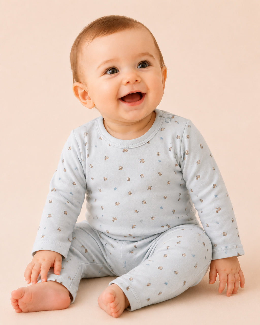 Baby wearing pale powder-blue long-sleeve two-piece set with acorn and stars print