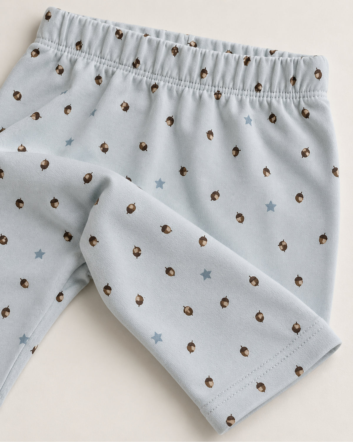 Pale powder blue acorn and stars trousers elastic waistband and stitched ankle hem detail