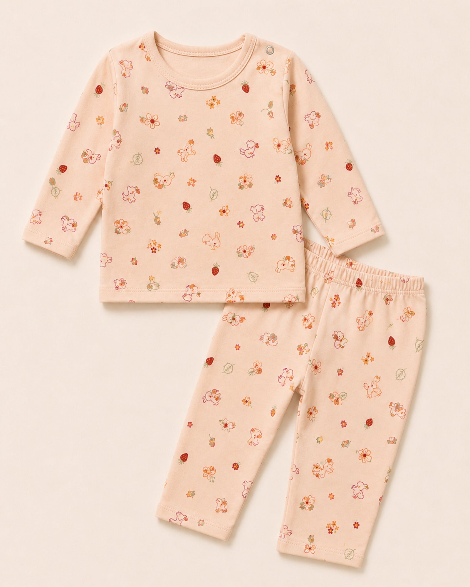 Pale peach-pink baby two-piece set with bunny, flower and strawberry print – front product view