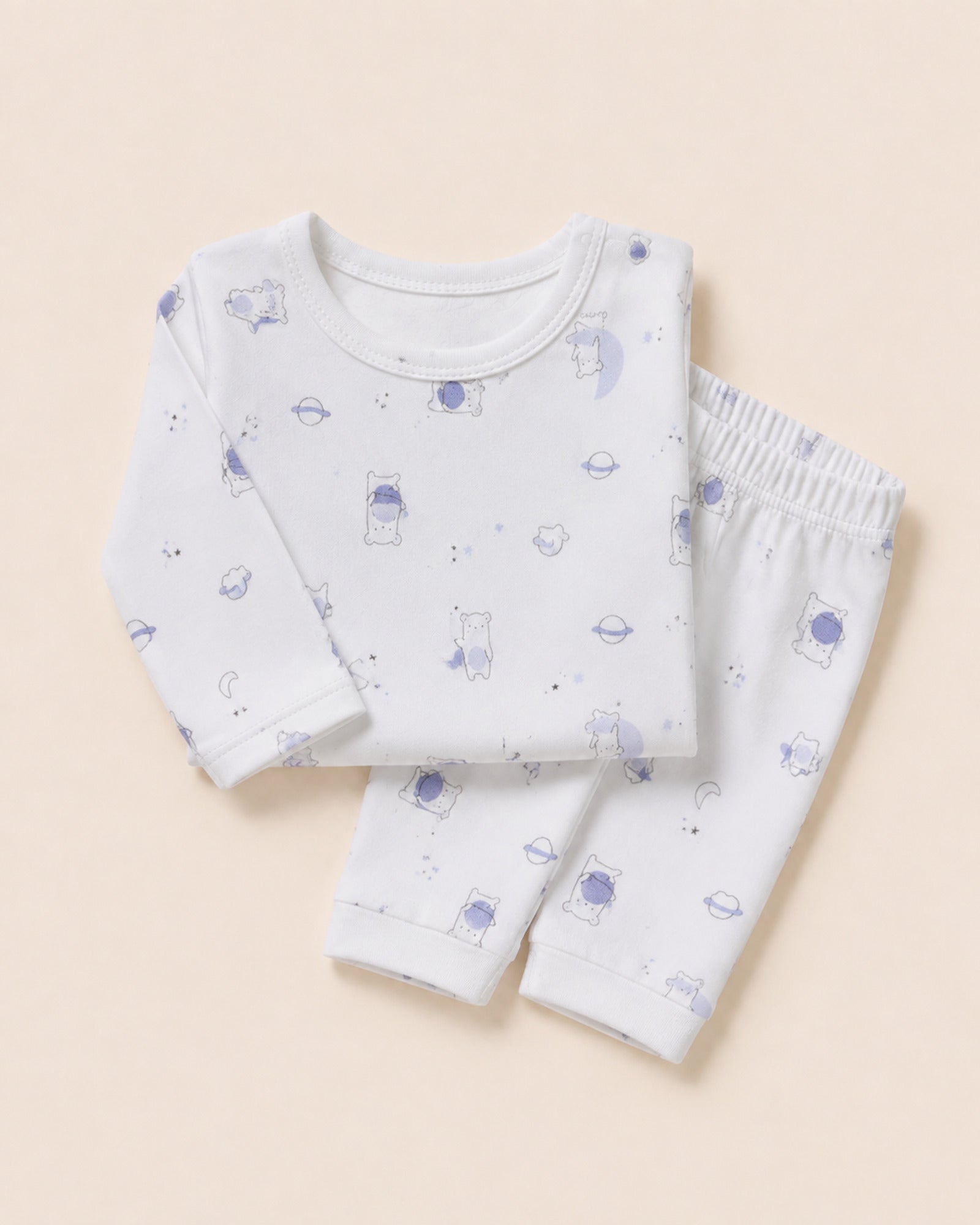 White baby two-piece set with teddy bear, moon and stars print – folded composition