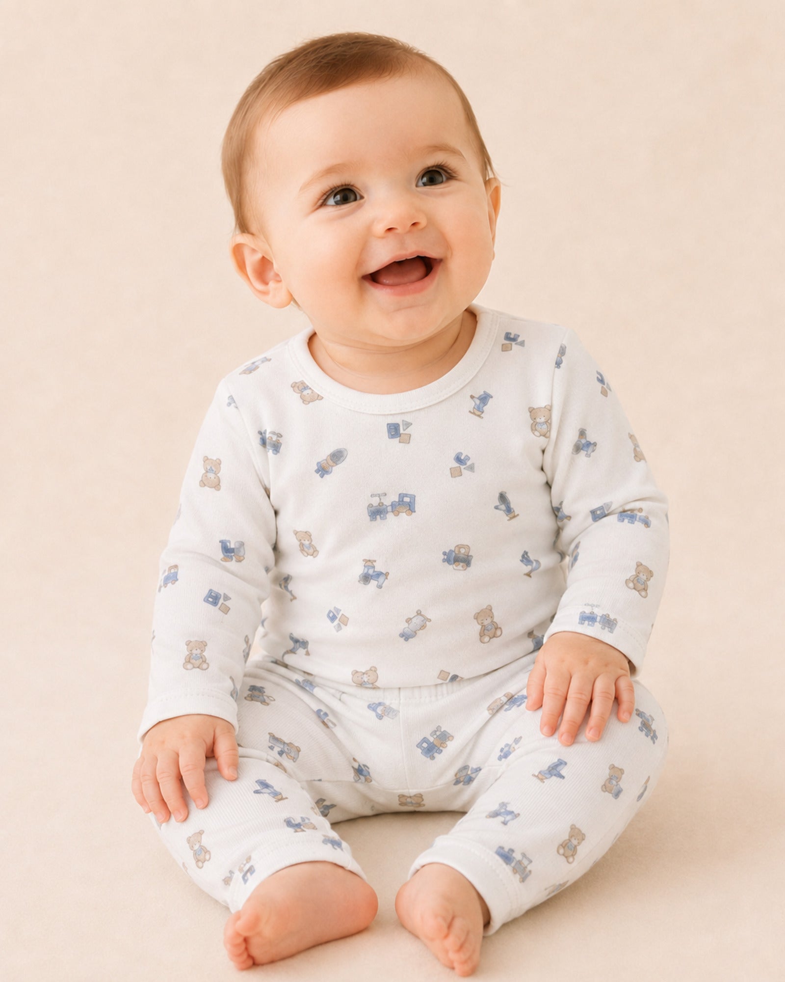 White baby two-piece set with teddy bear, train and toys print – infant model view