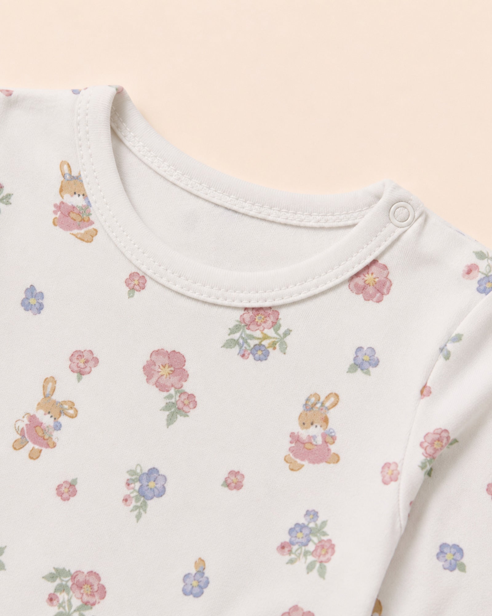 White baby two-piece set – neckline, shoulder snap and floral bunny print detail
