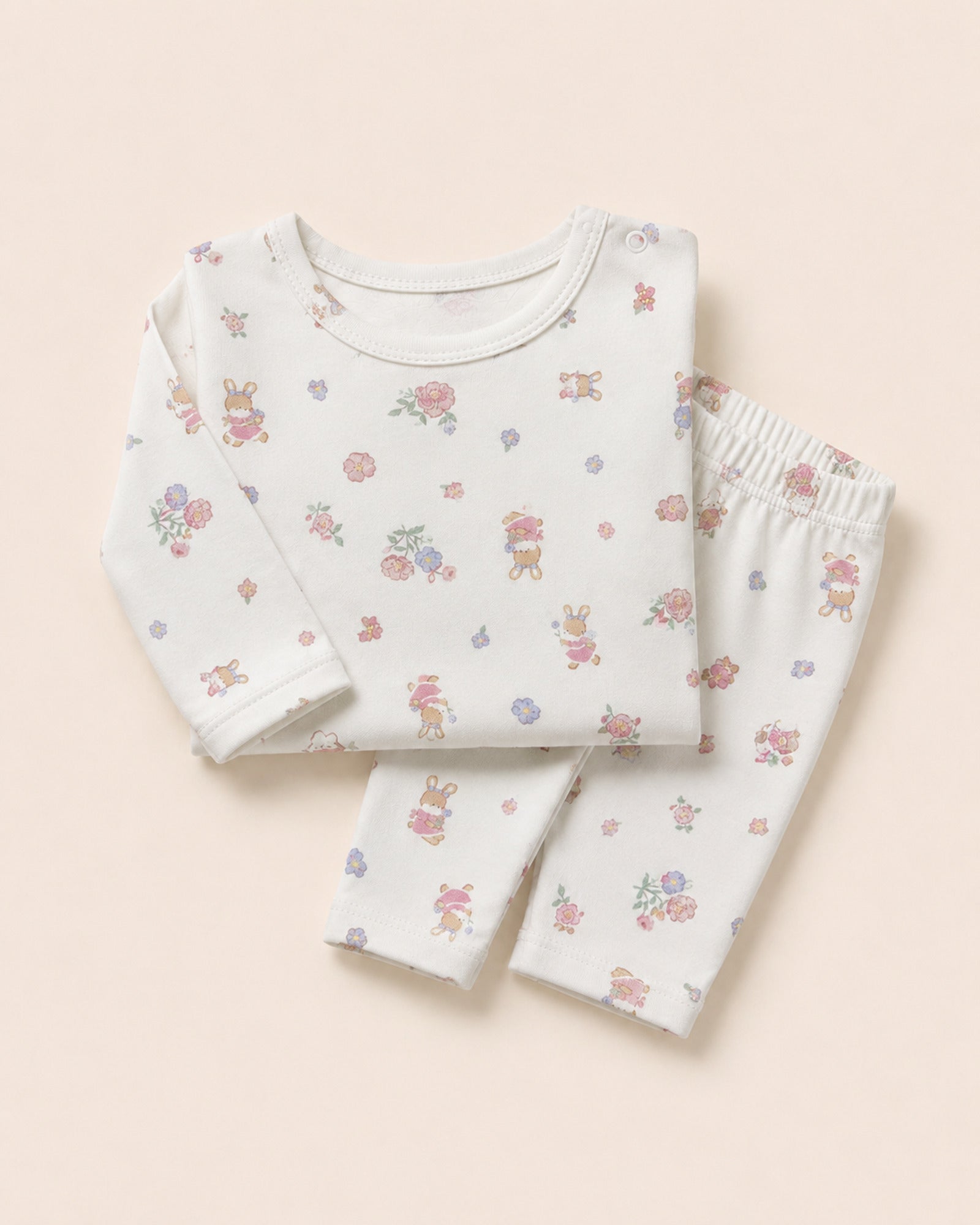 White baby two-piece set with floral bunny print – folded composition