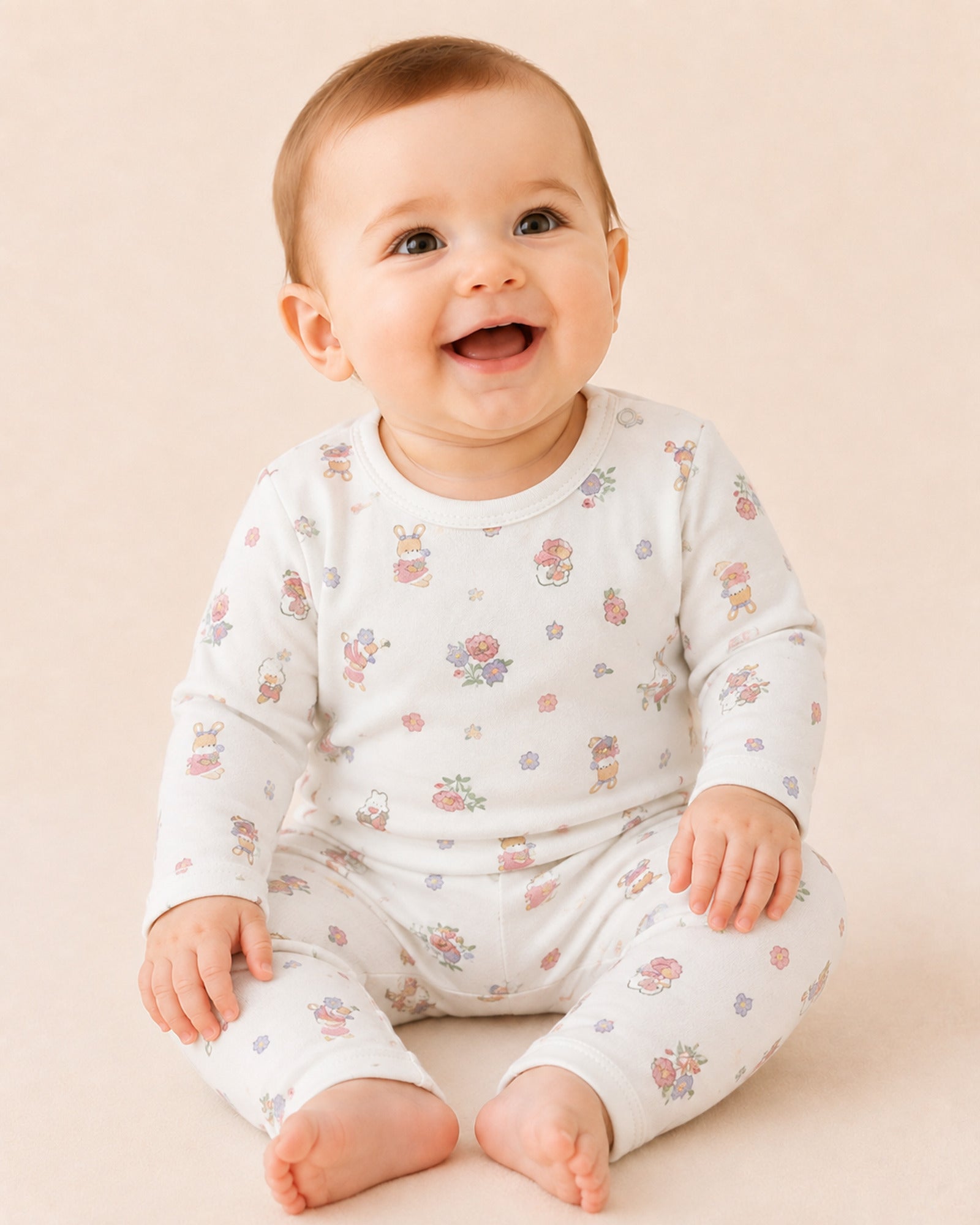 Baby wearing white two-piece set with floral bunny print