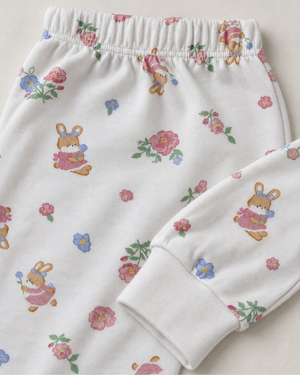White floral bunny print trousers elastic waistband and plain white ankle cuff detail
