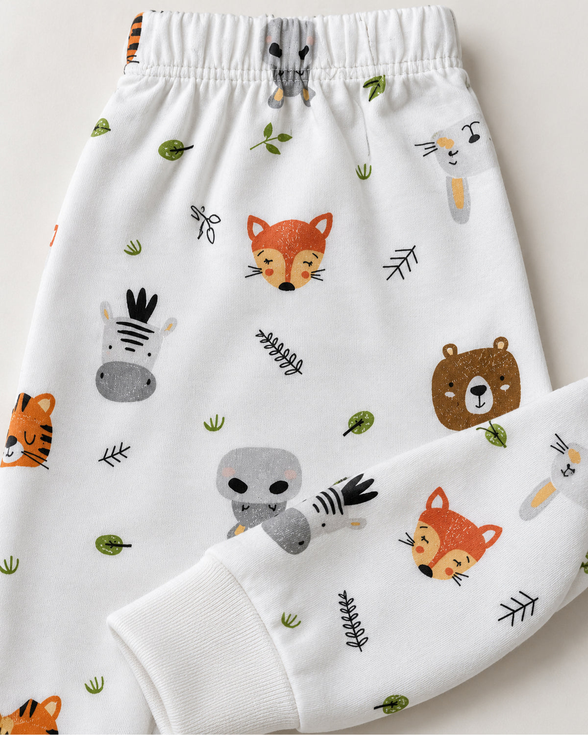 White colourful animal print trousers elastic waistband and plain ankle cuff close-up