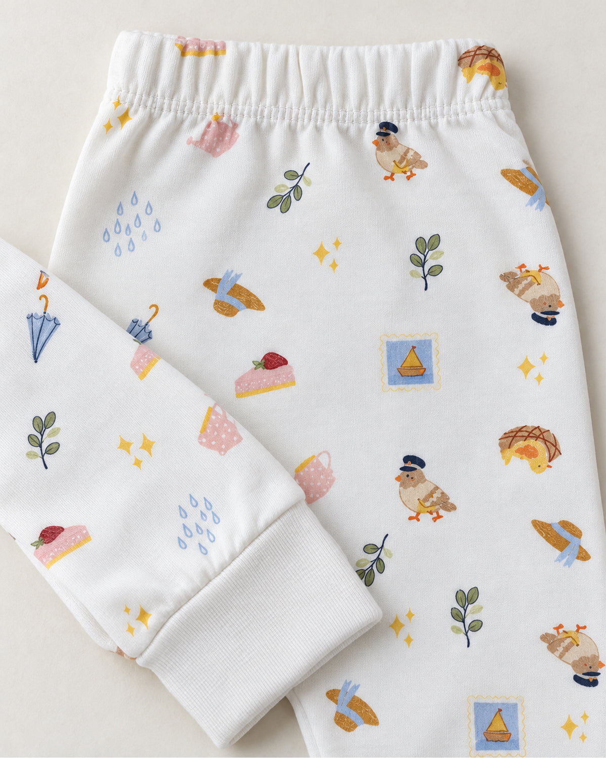 White picnic and travel print trousers elastic waistband and white ankle cuff detail