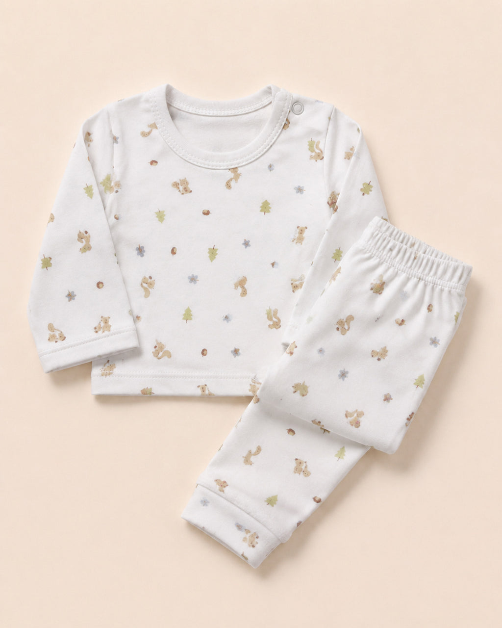 White squirrel woodland print baby set styled composition