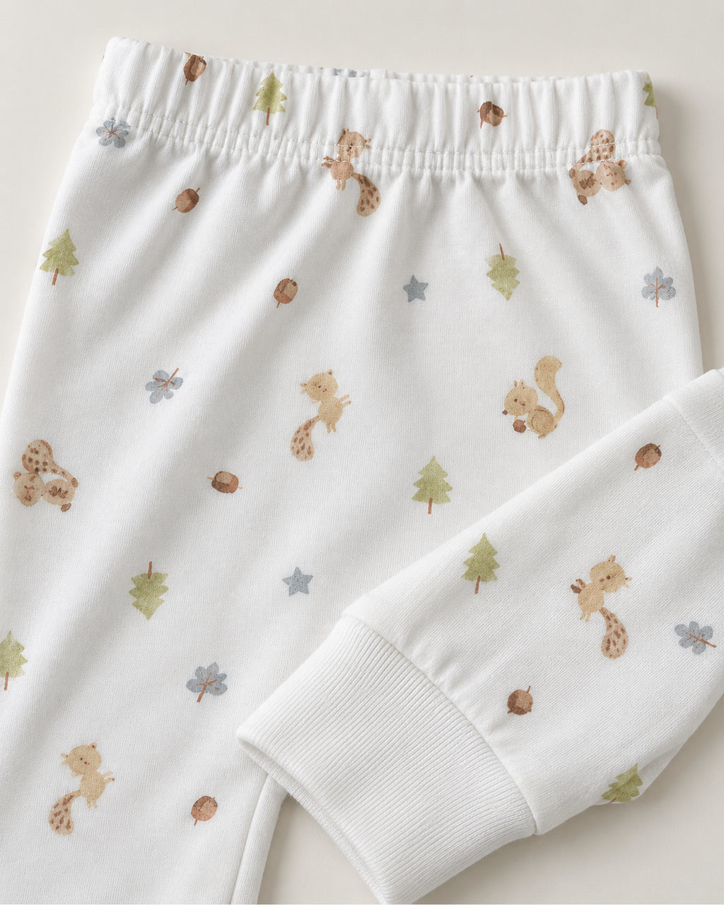 White squirrel woodland print trousers elastic waistband and plain ankle cuff close-up