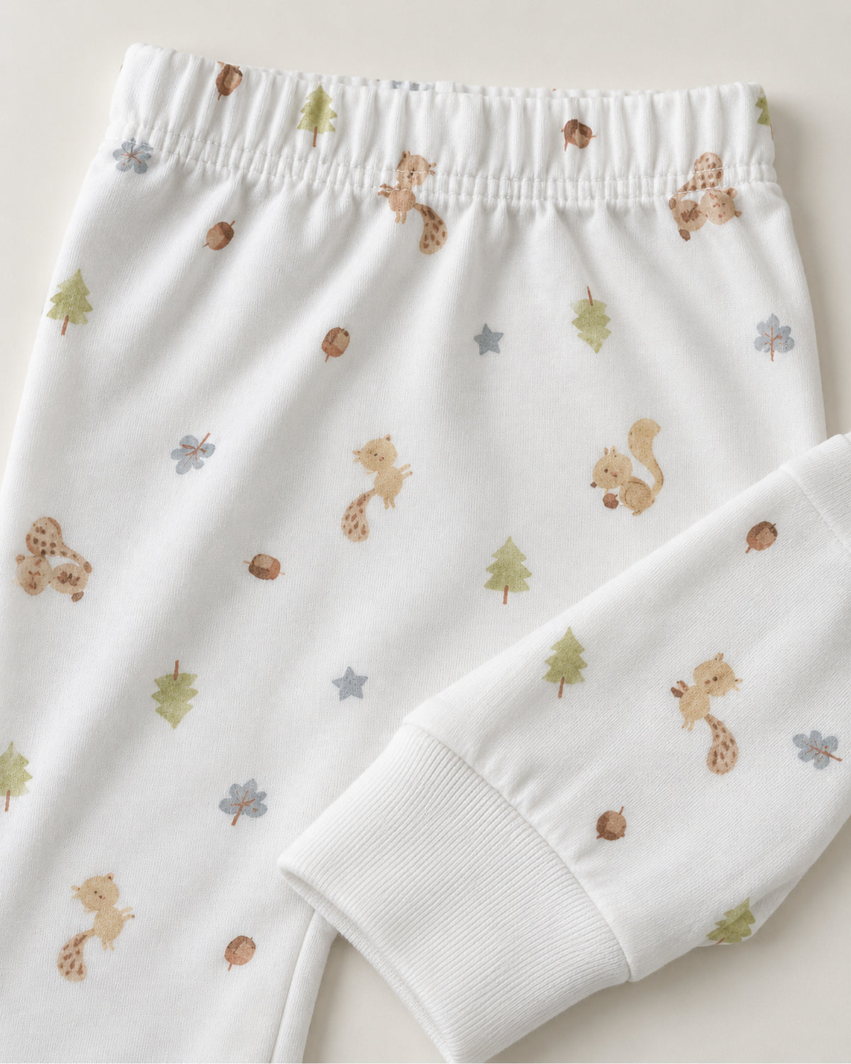 White squirrel woodland print trousers elastic waistband and plain ankle cuff close-up