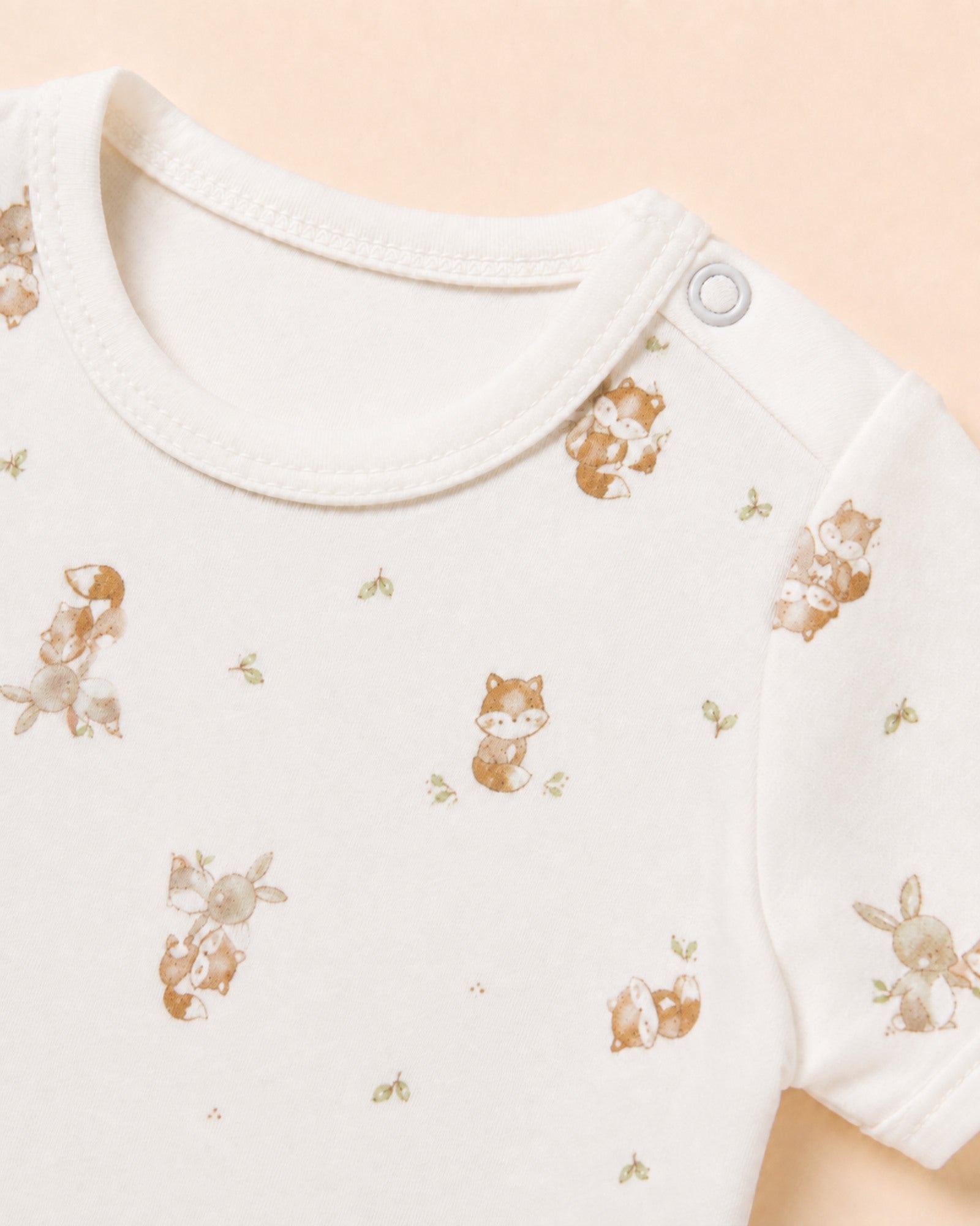 Single shoulder snap and original fox-and-bunny print detail