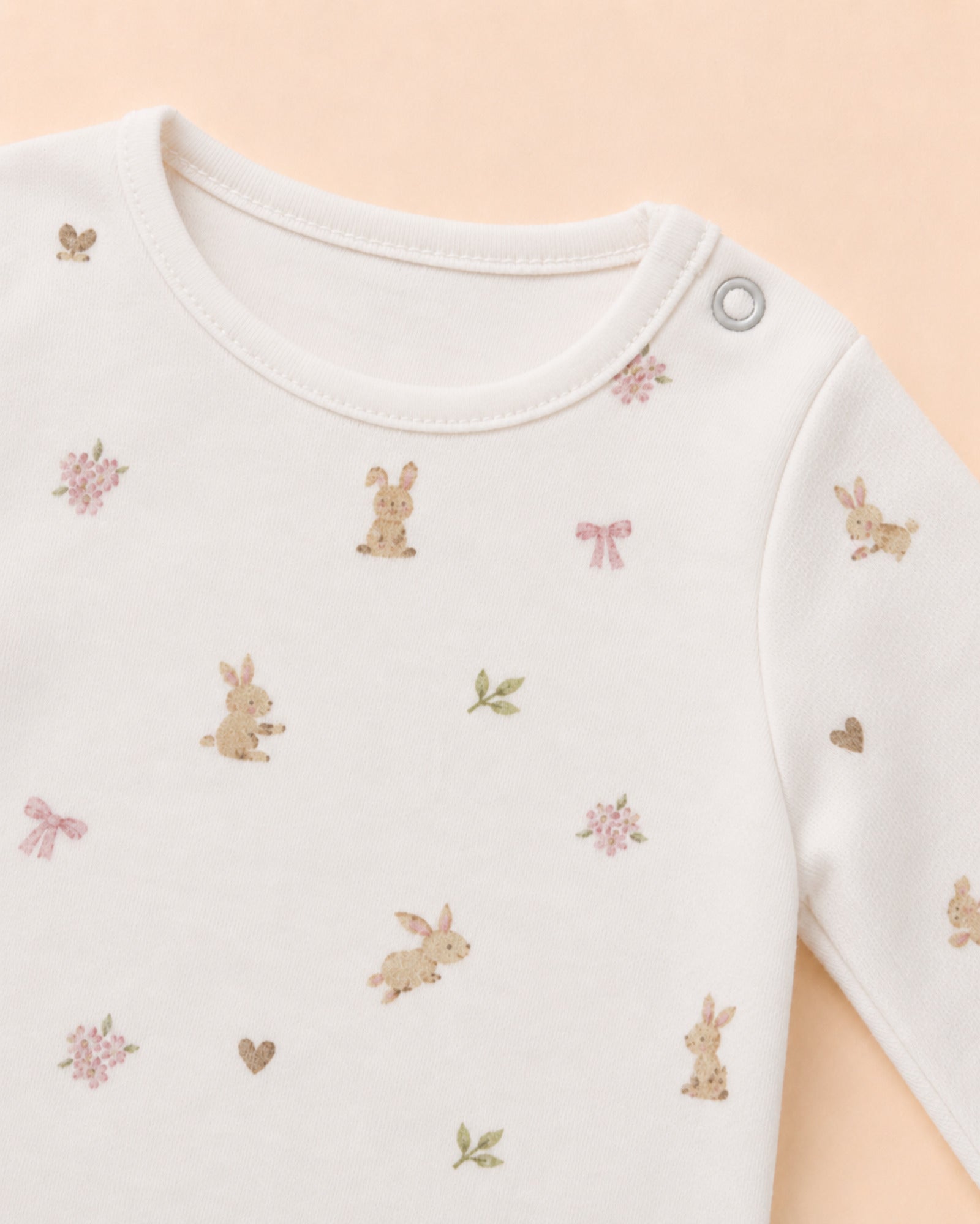 Single shoulder snap and original bunny, bow and flower print detail