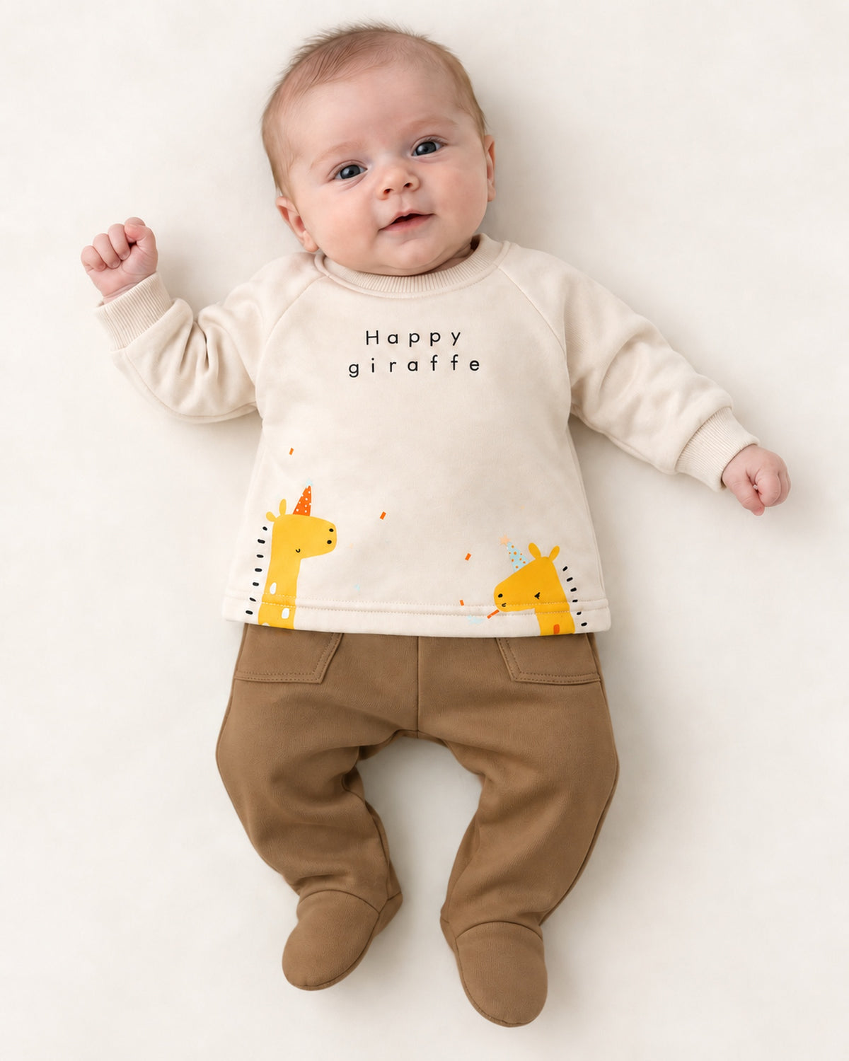 Cream and brown giraffe baby set, newborn model wearing one month footed trousers