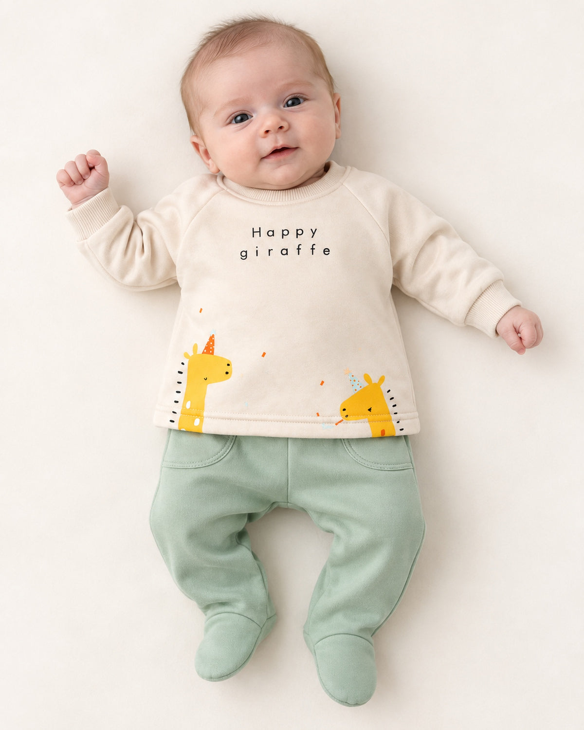 Cream and mint giraffe baby set, newborn model wearing one month footed trousers