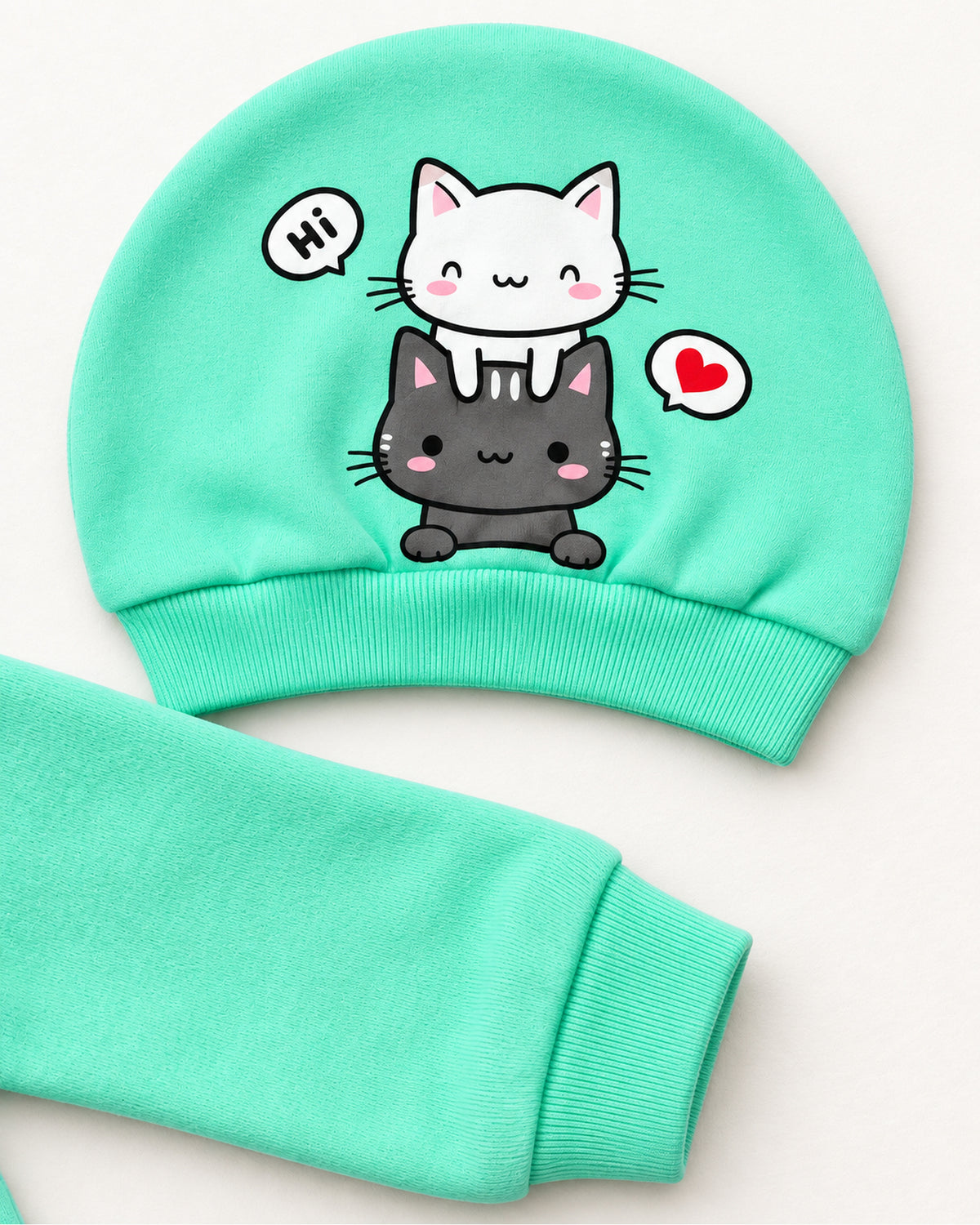 Mint cat sleepsuit set matching two-cat hat and sleeve cuff close-up