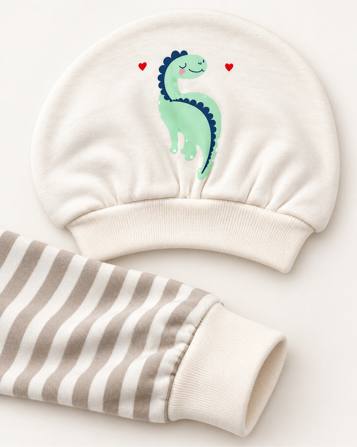 Pistachio dinosaur set printed hat and striped sleepsuit ankle cuff detail