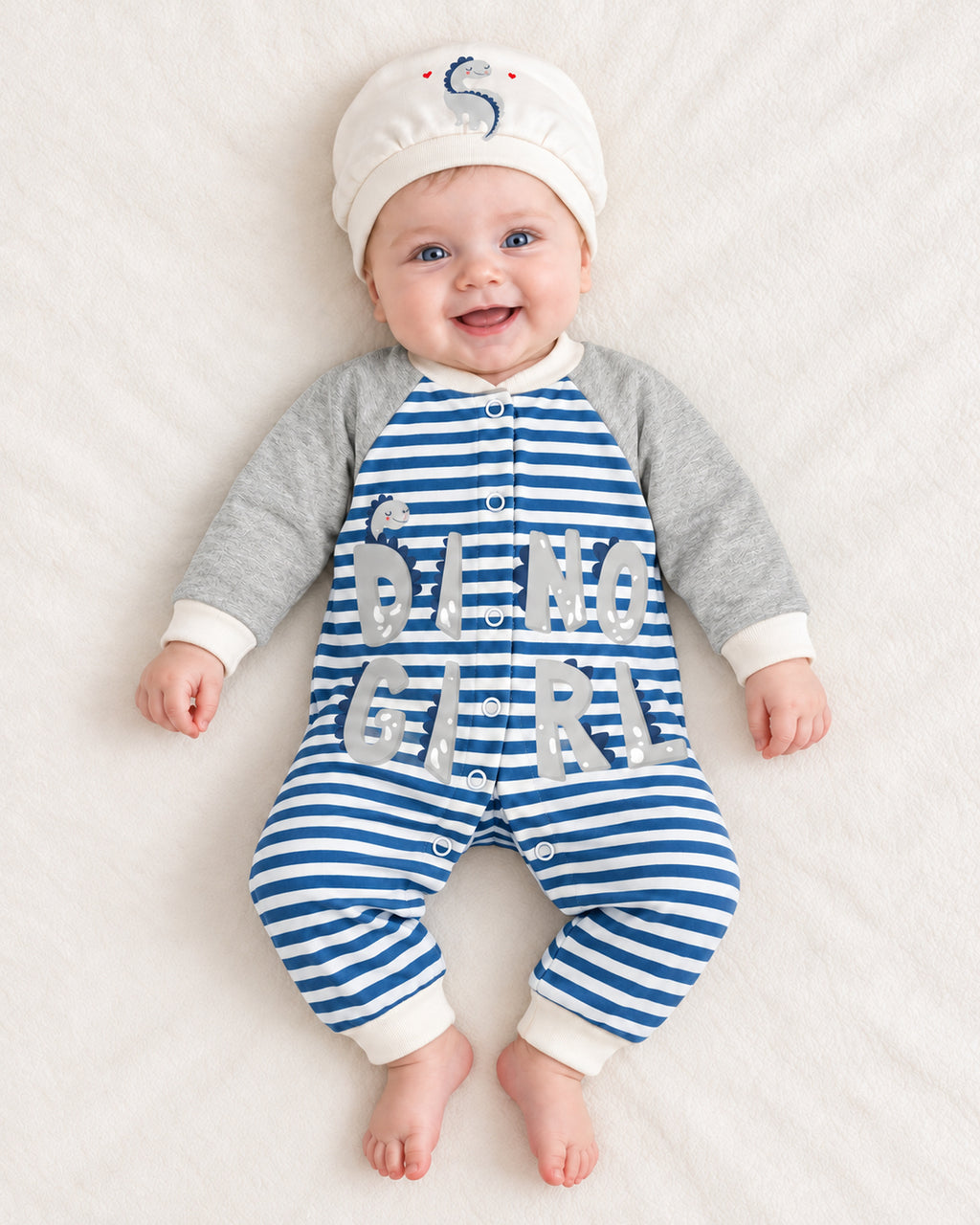 Baby Dream grey & blue dinosaur sleepsuit and hat set, baby wearing the complete outfit