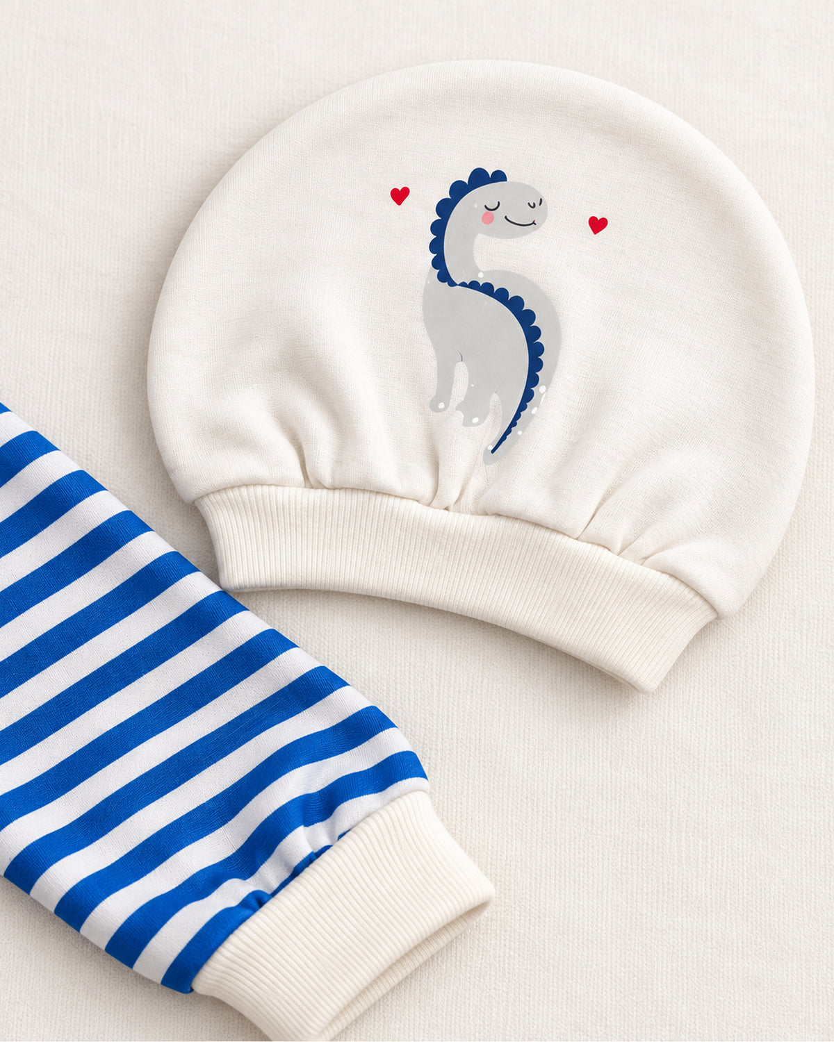Grey and blue dinosaur set printed hat and striped sleepsuit ankle cuff detail