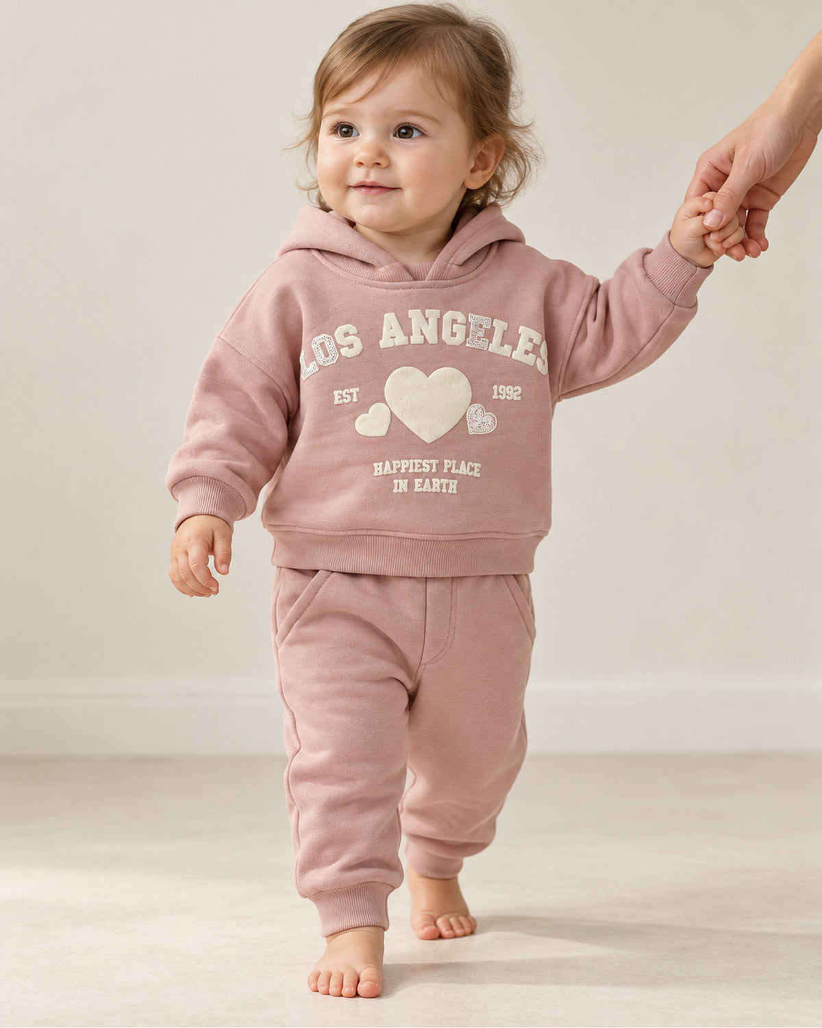 Dusty pink baby girl sequin-heart hoodie and joggers set, two-piece outfit on a baby girl