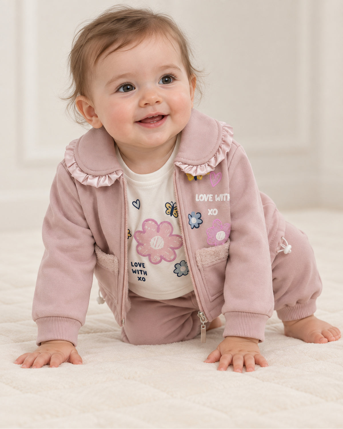 Dusty rose-pink baby girl satin-ruffle jacket, floral top and joggers set, complete three-piece outfit on a baby girl