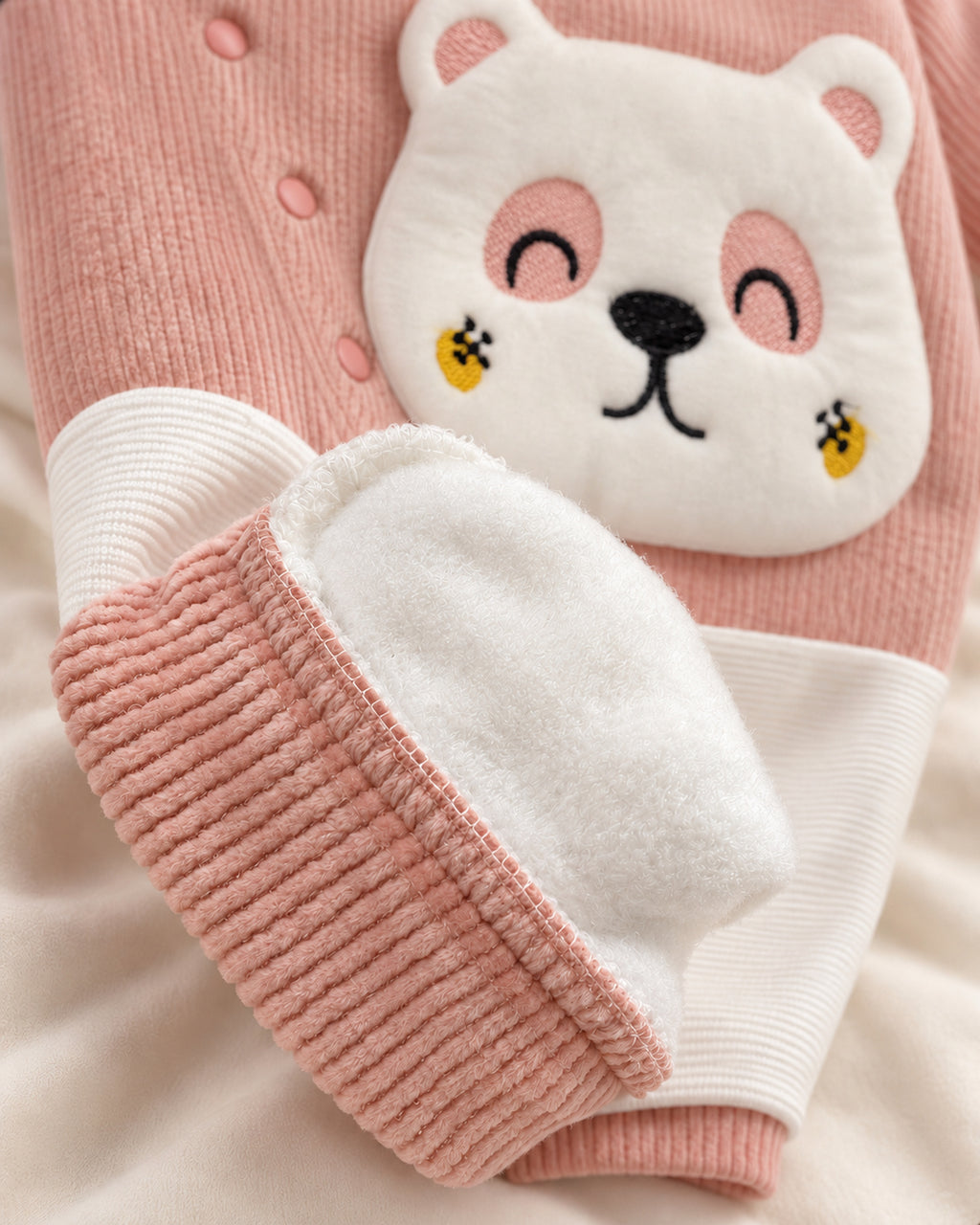 Dusty rose baby sleepsuit, plush lining and ankle cuff detail