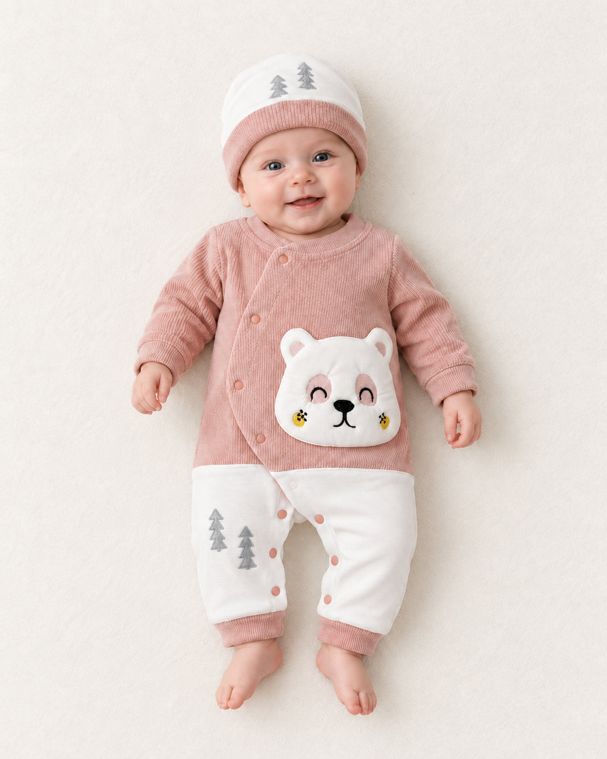 Dusty rose baby bear sleepsuit, matching hat worn by an infant