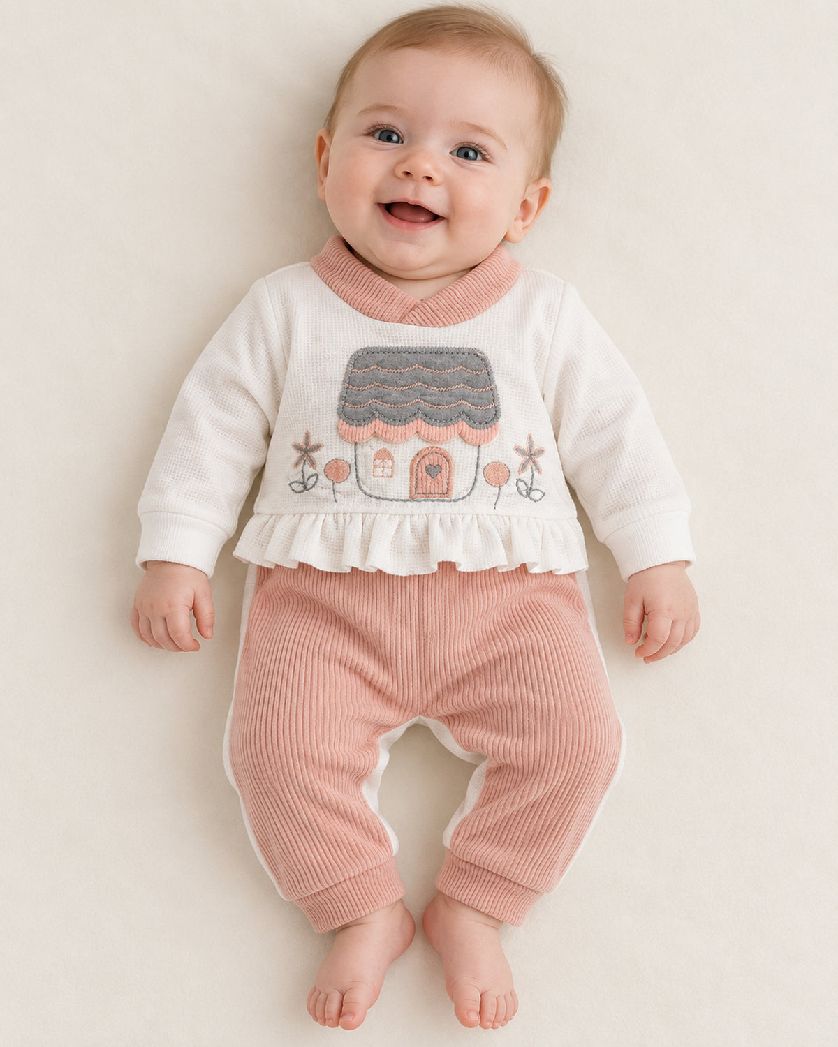 Dusty Rose baby house set, sleepsuit worn by an infant